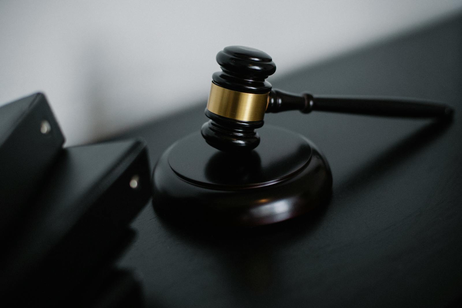 Photo by Sora Shimazaki Close-up of a wooden gavel on a desk, symbolizing justice and legal authority.