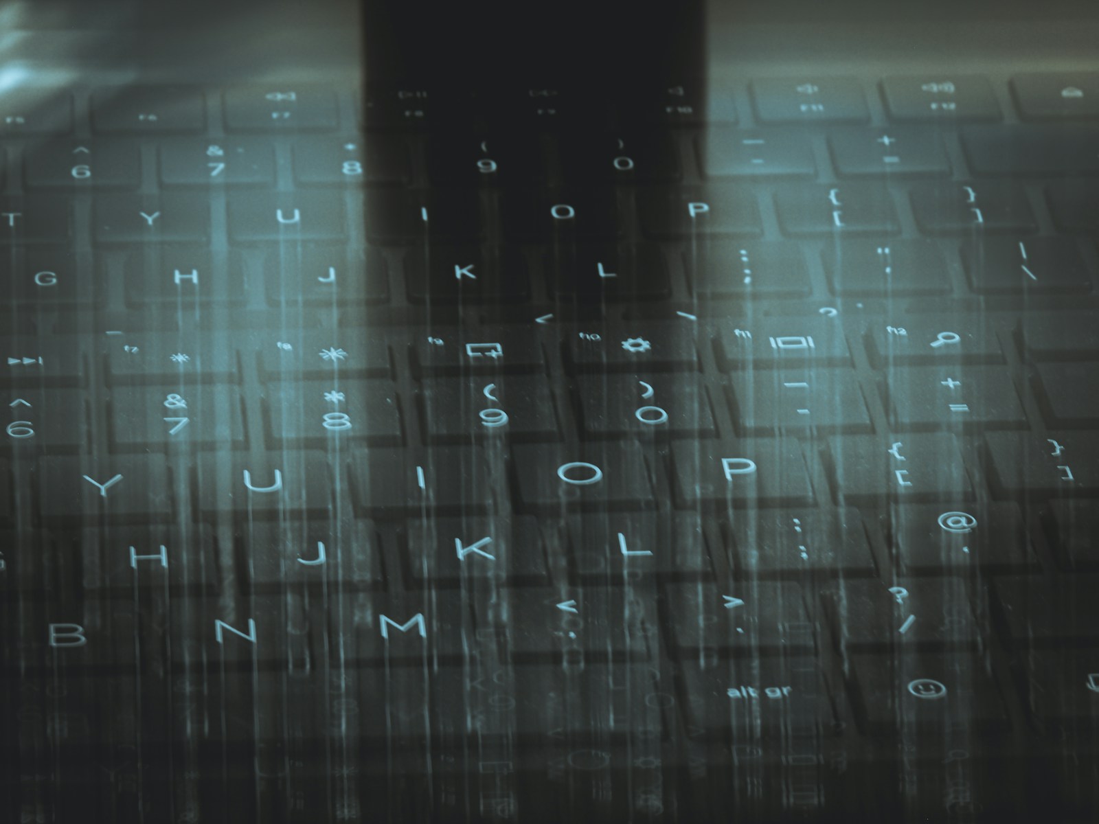 A computer keyboard with a sky background