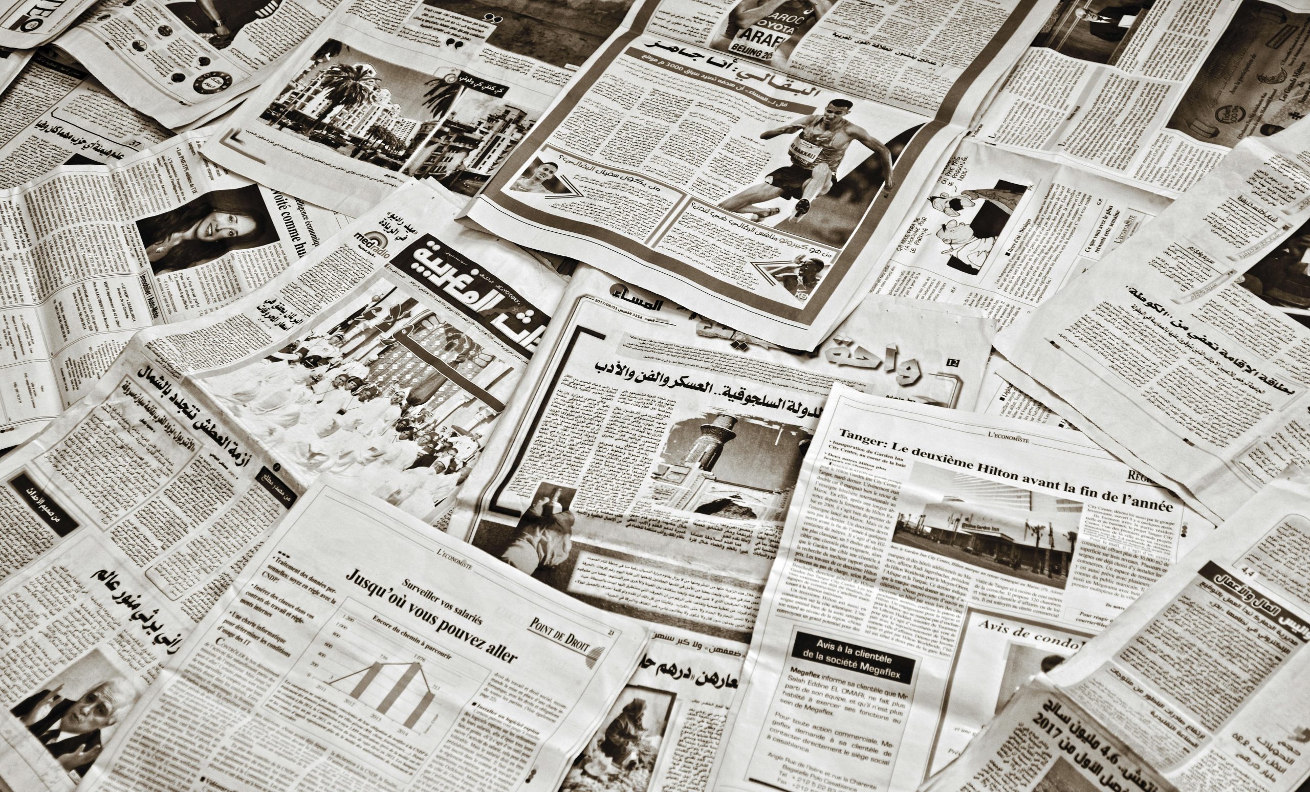 Scattered arabic newspapers display